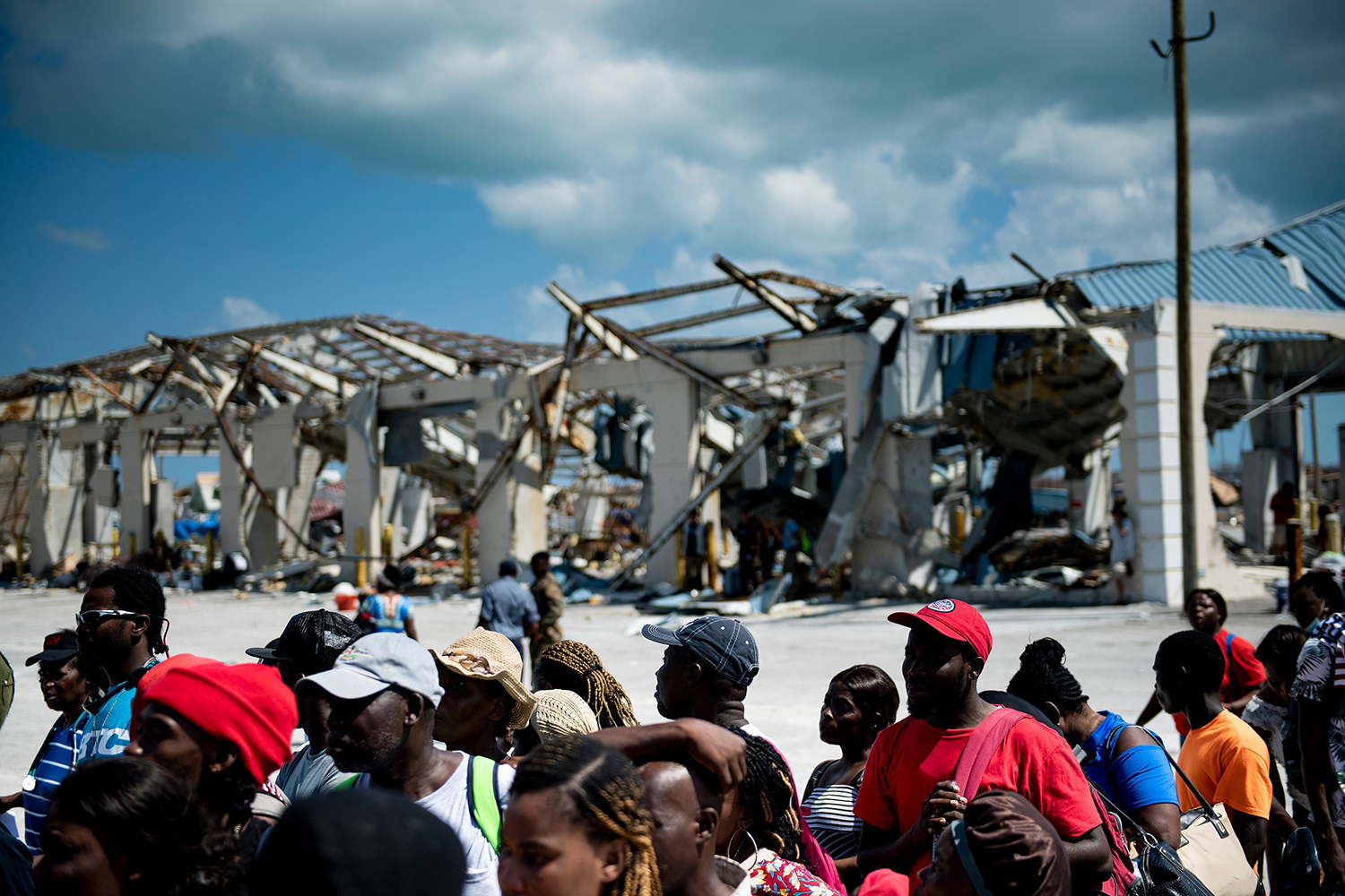 People board a cargo ship for evacuation to Nassau after Hurricane Dorian