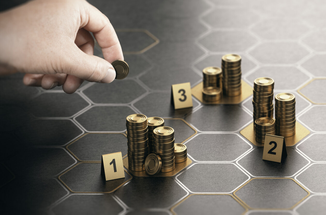 Human hand stacking generic coins over black background with hexagonal golden shapes. Concept of angel investor and investing in startup companies. Composite image between a hand photography and a 3D background.