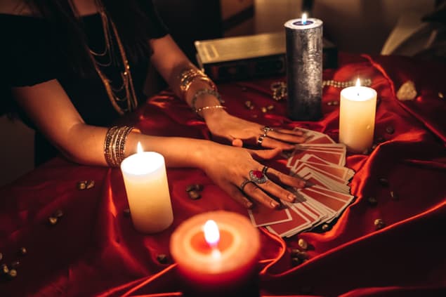 Hands of a fortune teller reading tarot cards