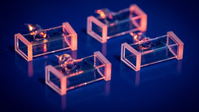 Photo of four iodine vapour cells, which are glass boxes a few centimetres long