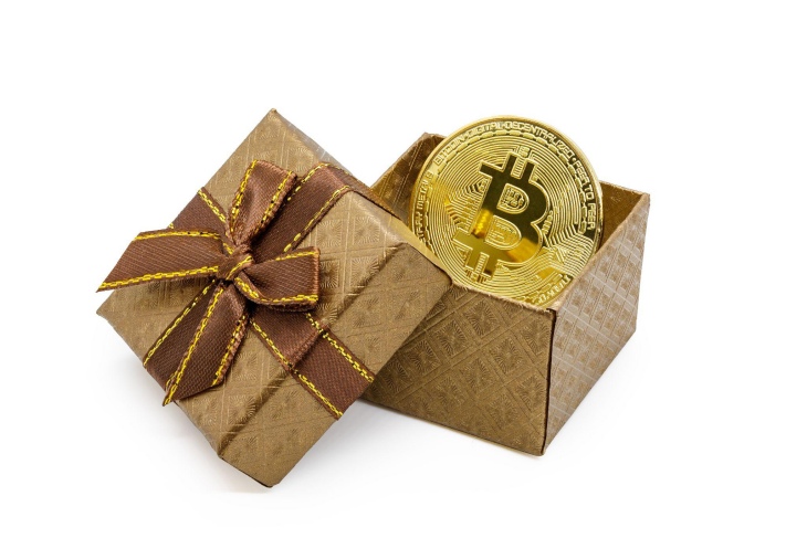 bitcoin symbol on a gold coin in a gold gift box