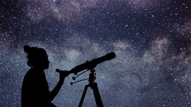 Woman with telescope watching the stars. Stargazing woman night sky