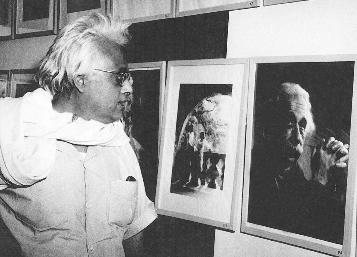 S N Bose looking at a photograph of Albert Einstein