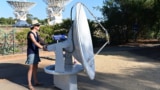 Australian woman steering a radio dish at the Telescope Compact Array near Narrabri NSW