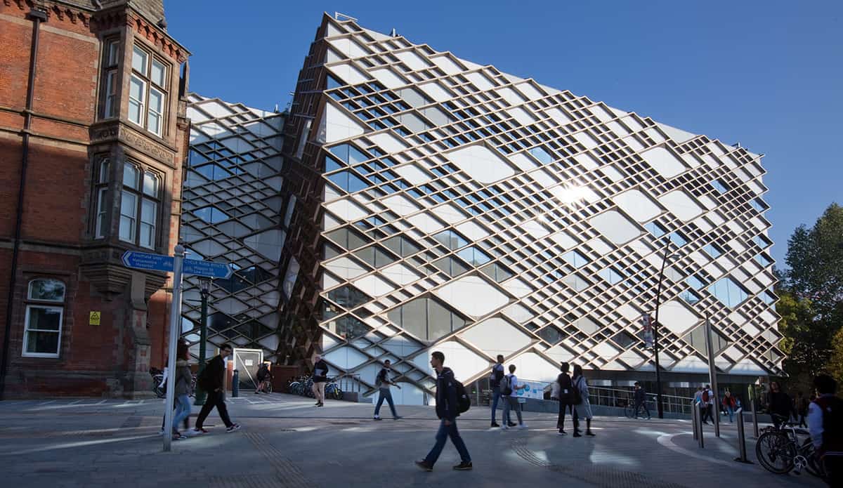 Large rectangular building with a glass facade divided into different-sized diamond shapes